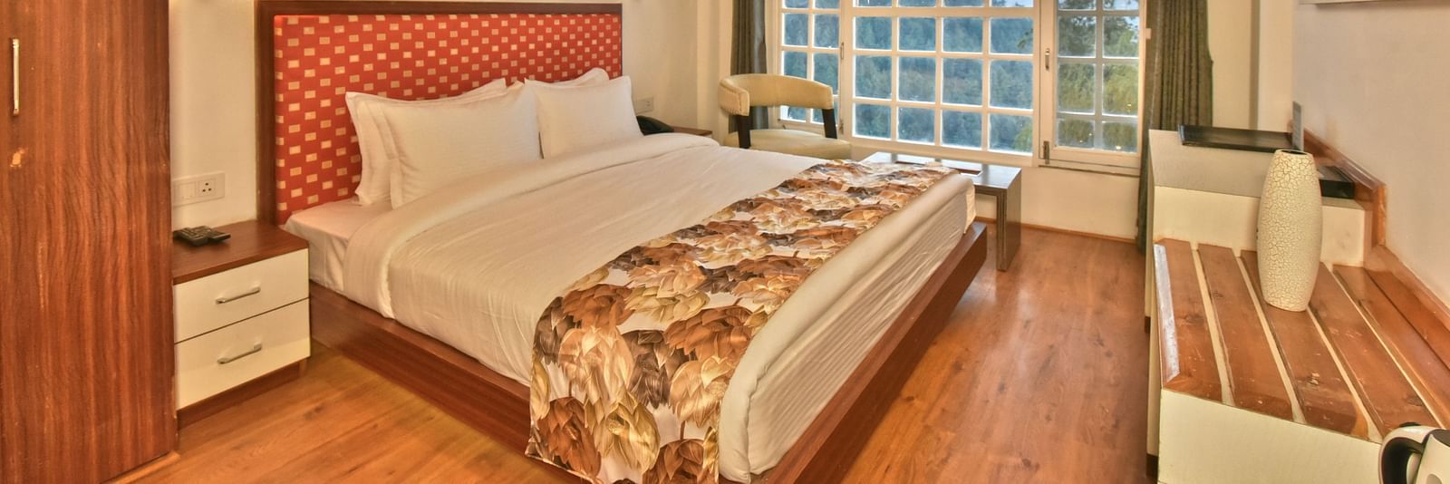 Bedroom with a wooden wardrobe next to it at DLS Hillcrest Resort, Shimla.